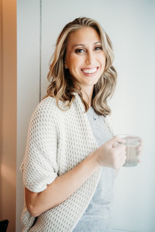 An image of Bahn CPA founder Karen Bahn holding a cup of  coffee. 